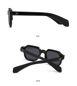 Détail de lunettes de soleil noires vintage avec rivets étoiles dorés sur les branches