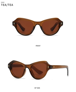 Detail von bernsteinfarbener Schmetterlings-Sonnenbrille mit Metallnieten und Gläsern