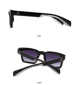 Détail des lunettes de soleil carrées noires avec rivets dorés et verres dégradés violets
