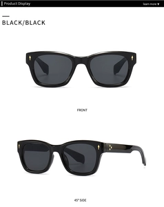 Detail view of black square sunglasses with decorative gold metal rivets and wide frame