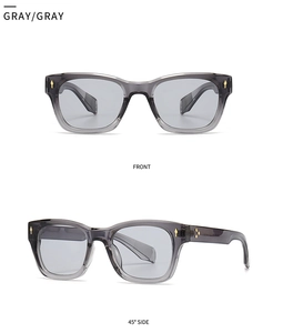 Close-up of thick square gray transparent sunglasses with golden diamond rivets