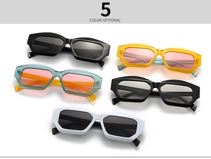 Flat lay of vintage cat-eye sunglasses in five colors including black, white and yellow