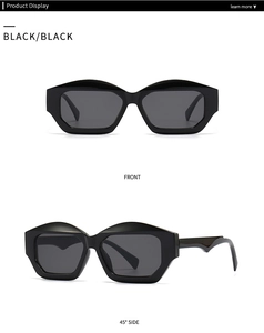Detail view of black cat eye sunglasses with thick geometric frames and wave-shaped temples