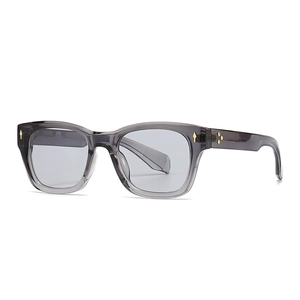 Square transparent grey sunglasses with decorative gold metal rivets in a classic frame