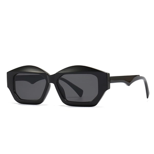 Fashionable black cat eye sunglasses with thick geometric frames and dark grey lenses