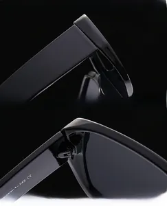 Detail view of reinforced hinges and CE mark on black square oversized sunglasses