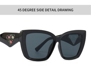 Close-up of cat-eye sunglasses with triangular floral detail on the black temple arm