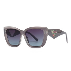 Vintage cat eye sunglasses with gray frames and floral triangle detail on temples