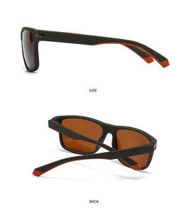 Detail view of modern narrow rectangular sunglasses with orange inner frame and dark lenses