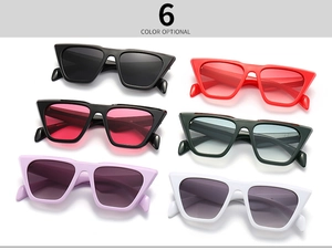 Flat lay of cat eye sunglasses in six vibrant colors with gradient lenses