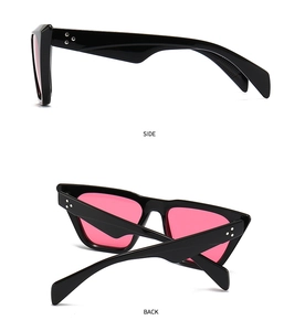 Detail view of cat eye sunglasses side temple with silver studs and pink lenses
