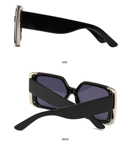 Detail view showing golden metal edge trim and hinges on black square frame sunglasses