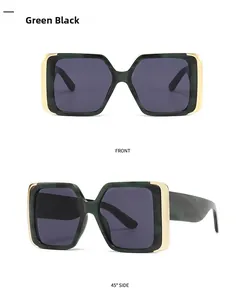 Detail view of square cat-eye sunglasses with green marble pattern and gold metal accents