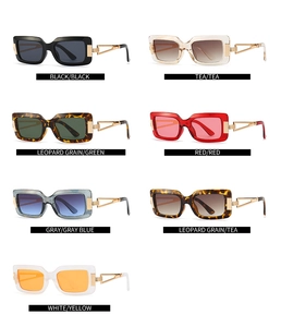 Detail view of vintage rectangle sunglasses featuring a unique cutout gold metal temple design