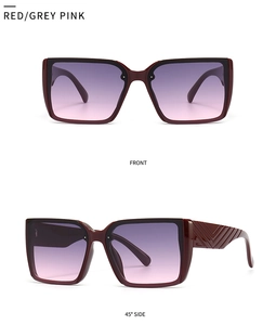 Detail view of red square sunglasses with gradient pink lenses and V-textured temples