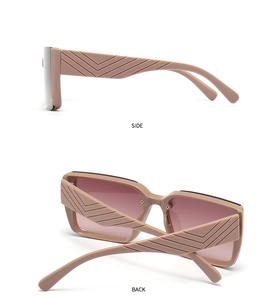 Detail of pink oversized sunglasses showing the V-pattern embossed texture on the side temples