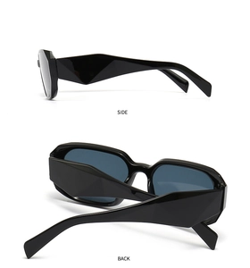 Detail view of black geometric sunglasses showing thick frames and angular side arms