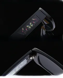 Détail des charnières métalliques renforcées et motif papillon sur lunettes de soleil