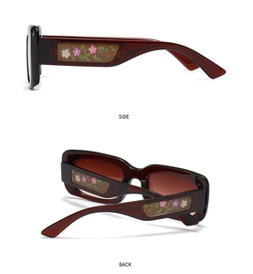 Detail of rectangular floral patterned temples on translucent dark red square sunglasses
