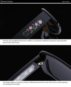 Detailed macro view of black sunglasses frame with pink floral patterns and metal hinges