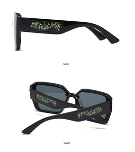 Detailed side and back view of black square sunglasses with floral butterfly temple patterns