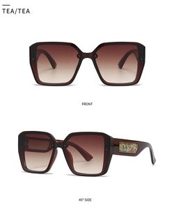 Detail view of square oversized tea sunglasses with butterfly patterns on the side temples