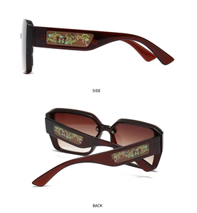 Side and back view of burgundy oversized sunglasses with bohemian floral temple art