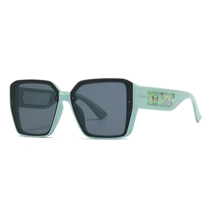 Modern oversized square sunglasses in mint green and black with floral butterfly temple design