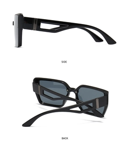 Détail de lunettes de soleil carrées noires avec branches géométriques ajourées et accents métal