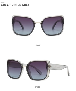 Macro view of square oversized sunglasses with grey purple gradient lenses and gold hinges