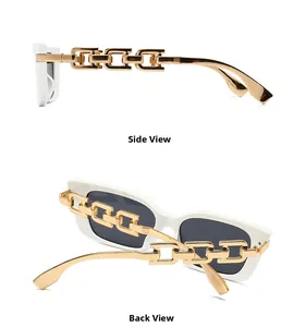 Detail view of white cat-eye sunglasses featuring chunky gold metal chain temples