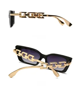 Close-up of golden metal chain temples and purple gradient lenses on cat-eye sunglasses