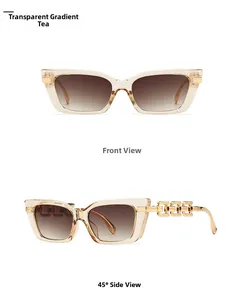 Detail of cat eye sunglasses with gold chain hollow temples and brown gradient lenses