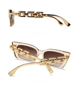 Detailed side view of cat-eye sunglasses featuring golden chain temples and champagne frames
