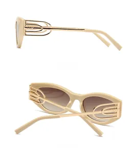 Detail view of cat eye sunglasses showing hollow metal temples and beige frame design