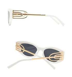 Detail view showing side and back of white cat eye sunglasses with hollow gold temples
