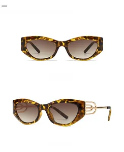 Detail of leopard cat-eye sunglasses with golden metal link and gradient tea lenses