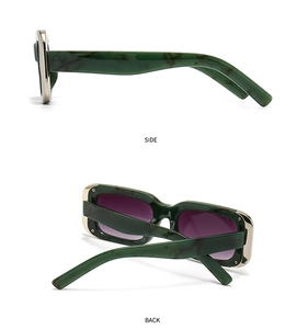 Detail view of cat eye sunglasses showing green marble frame and side metal rivets