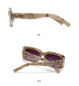 Detail view of retro marble-pattern frames with golden accents and purple lenses