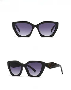 Detail of cat-eye sunglasses with black frame, purple gradient lenses and triangle accent