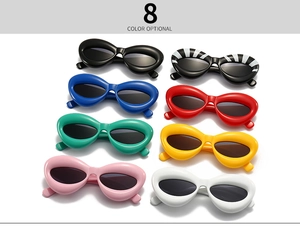 Flat lay of futuristic polygon sunglasses in eight vibrant colors with bold frames