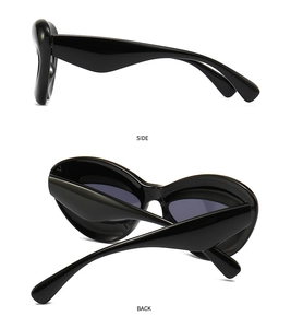 Side and back view of thick glossy black frame futuristic sunglasses with dark lenses