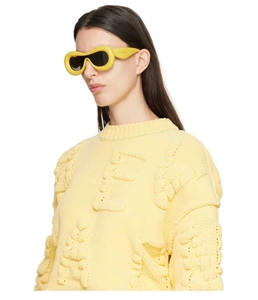 Detail of yellow knit sweater with 3D texture and futuristic inflated sunglasses