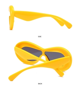 Side and back view of chunky yellow polygonal sunglasses with dark gray lenses