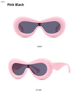Detail of pink chunky puffy sunglasses with dark grey lenses and wide temples
