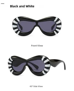 Close-up of futuristic polygon sunglasses with black and white radial stripe pattern