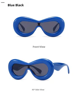 Macro view of blue wraparound sunglasses featuring thick frames and dark grey lenses