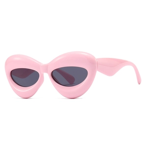 Pink chunky bubble frame sunglasses with dark oval lenses in Y2K futuristic style