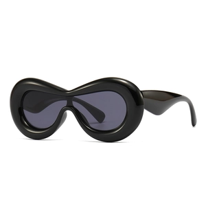 Futuristic inflated black oversized sunglasses with thick glossy frames and dark grey lenses