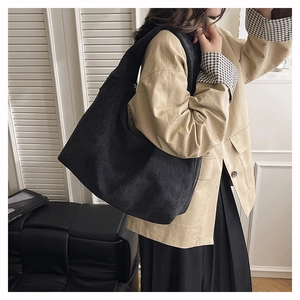 Detailed texture of black corduroy tote bag showing large capacity and hobo design